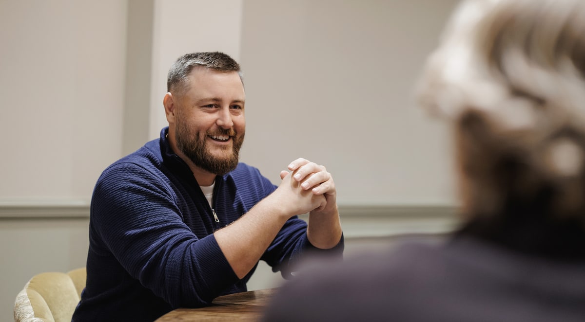 A Brightvision colleague in conversation with a client across a meeting table
